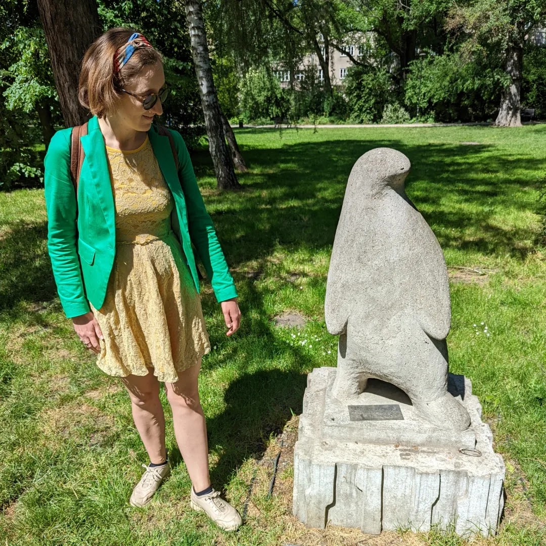 Woman with a statue of a penguin